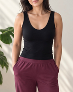 woman wearing scoop neck bra tank and plum pants