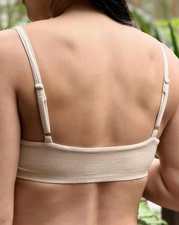 Beige bra worn by a person with a blurred natural background